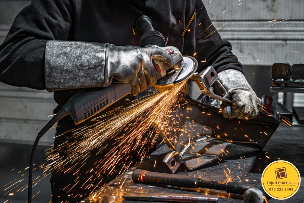 View of worker grinding a piece of metal